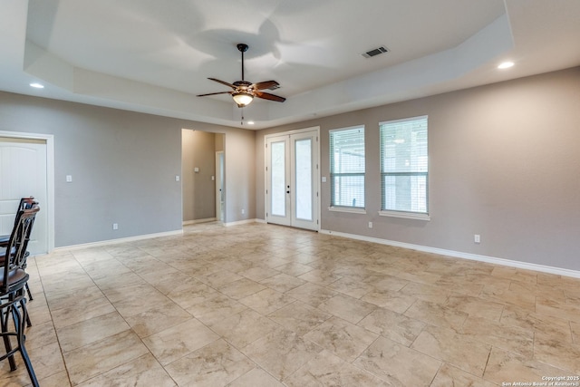 712 Crestview, Floresville, TX 78114 - unfurnished living room with recessed lighting, a tray ceiling, ceiling fan, baseboards, and french doors