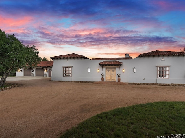 2835 Palomino Spgs, Bandera, TX 78003 - mediterranean / spanish-style home featuring a tile roof, french doors, stucco siding, and an attached garage