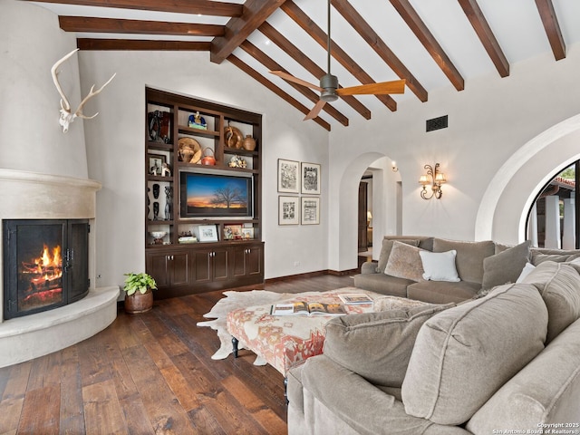 2835 Palomino Spgs, Bandera, TX 78003 - living room featuring arched walkways, wood-type flooring, a fireplace, and a ceiling fan