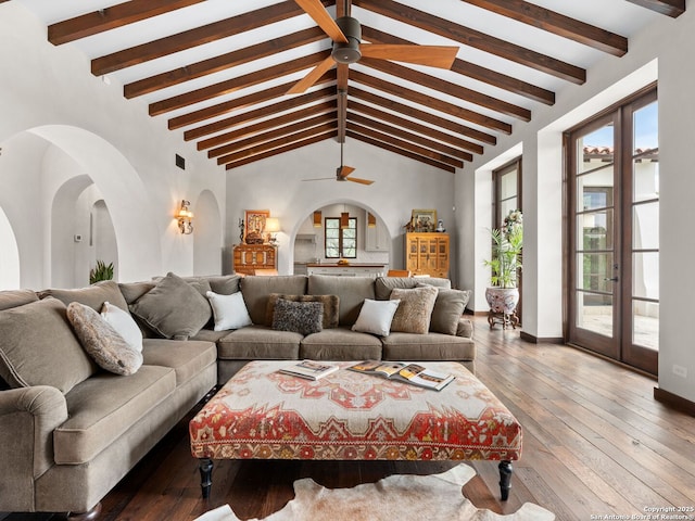 2835 Palomino Spgs, Bandera, TX 78003 - living room with ceiling fan, arched walkways, hardwood / wood-style floors, baseboards, and french doors