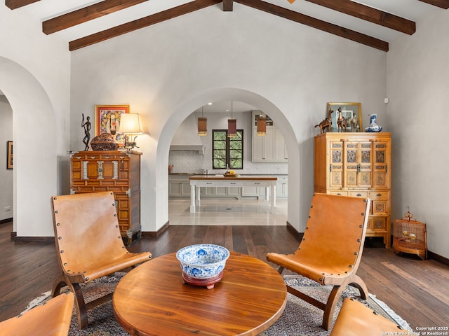 2835 Palomino Spgs, Bandera, TX 78003 - living area with arched walkways, wood-type flooring, beam ceiling, baseboards, and high vaulted ceiling
