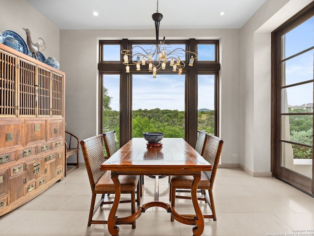 2835 Palomino Spgs, Bandera, TX 78003 - dining area featuring a chandelier, plenty of natural light, recessed lighting, light tile patterned floors, and baseboards