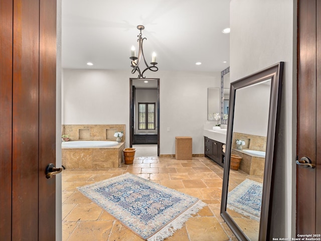 2835 Palomino Spgs, Bandera, TX 78003 - bathroom with stone tile floors, vanity, a bath, recessed lighting, and baseboards