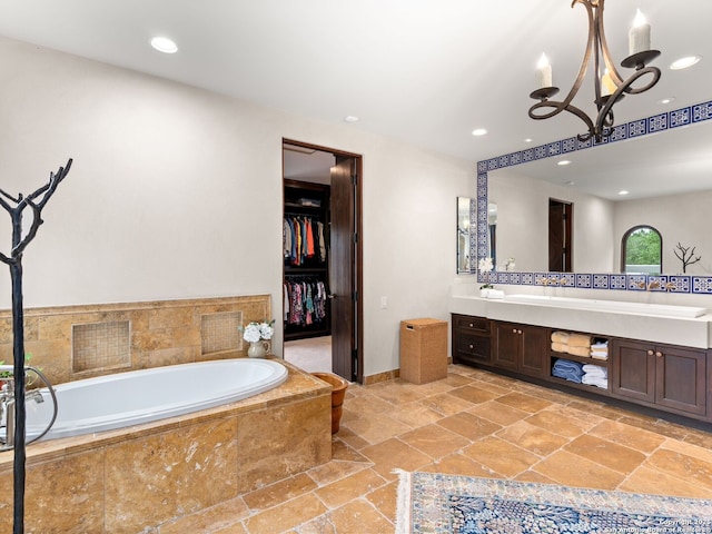 2835 Palomino Spgs, Bandera, TX 78003 - full bath featuring stone tile floors, double vanity, a chandelier, a garden tub, and recessed lighting