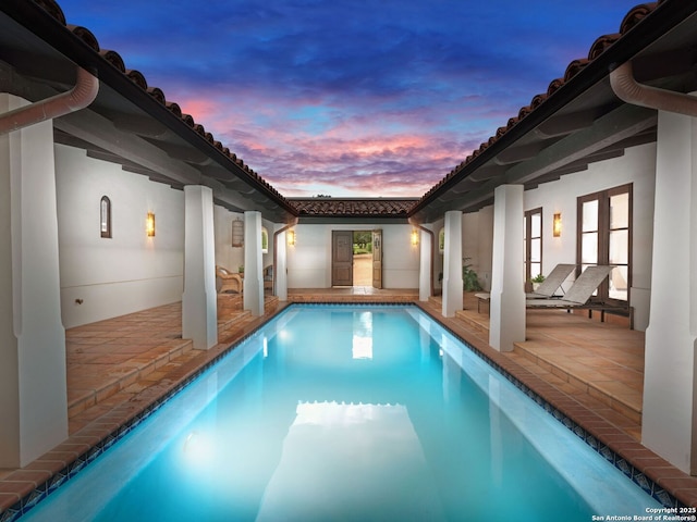 2835 Palomino Spgs, Bandera, TX 78003 - pool at dusk with an outdoor pool and a patio