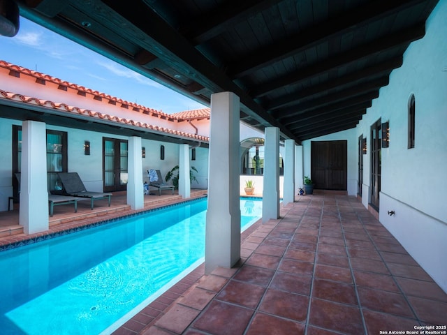 2835 Palomino Spgs, Bandera, TX 78003 - outdoor pool with french doors and a patio