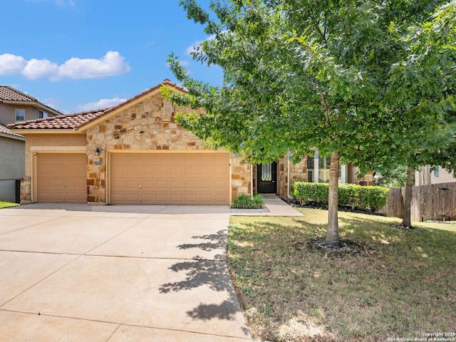 17922 Via Del Arbol, San Antonio, TX 78257 - view of front of house featuring stone siding, an attached garage, concrete driveway, a tiled roof, and stucco siding