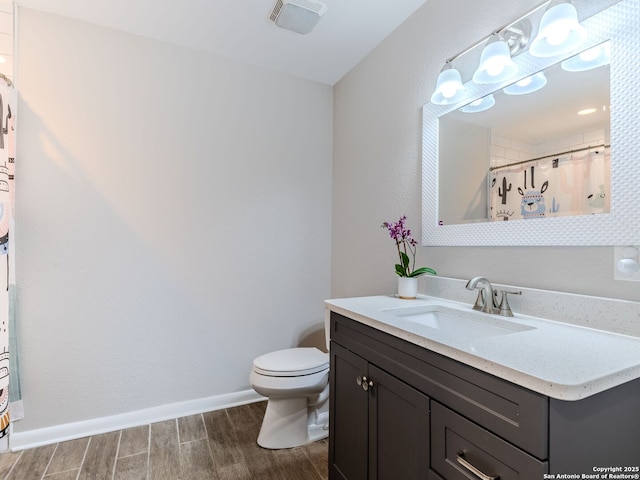 221 Harmon, San Antonio, TX 78209 - full bathroom with toilet, vanity, wood finished floors, baseboards, and a shower with shower curtain