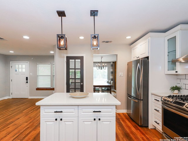 221 Harmon, San Antonio, TX 78209 - kitchen featuring appliances with stainless steel finishes, dark wood-style floors, baseboards, a chandelier, and light countertops