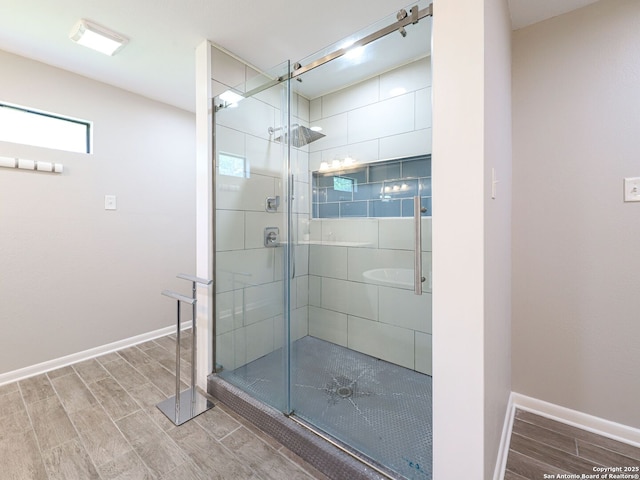 221 Harmon, San Antonio, TX 78209 - bathroom featuring wood finish floors, a stall shower, and baseboards