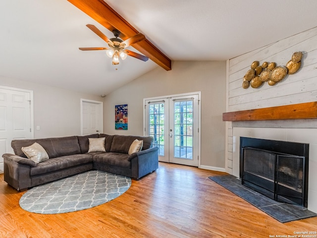221 Harmon, San Antonio, TX 78209 - living room with wood finished floors, a ceiling fan, french doors, and a large fireplace