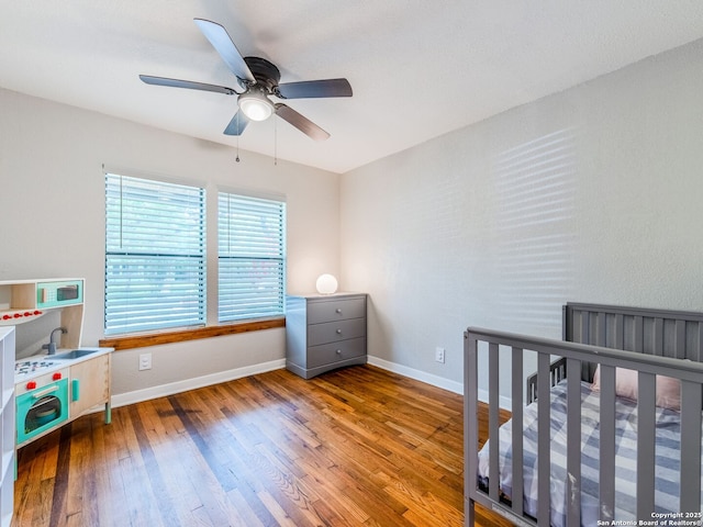 221 Harmon, San Antonio, TX 78209 - bedroom with wood finished floors, baseboards, a sink, and ceiling fan