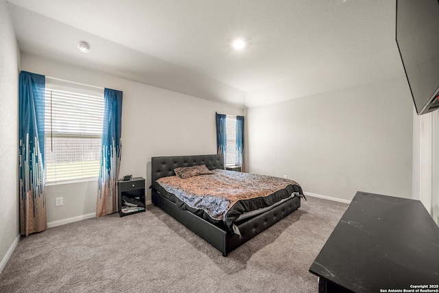 31646 Untrodden Way, Bulverde, TX 78163 - bedroom with carpet flooring, multiple windows, baseboards, and vaulted ceiling