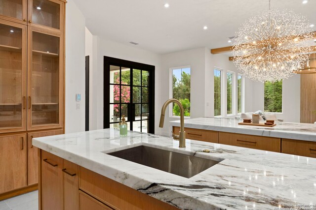6 Turin Ct, San Antonio, TX 78257 - kitchen with a sink, a chandelier, light stone countertops, and recessed lighting