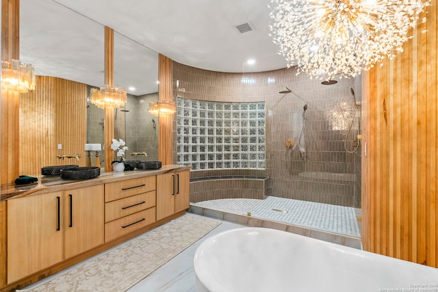 6 Turin Ct, San Antonio, TX 78257 - bathroom featuring a chandelier, double vanity, a walk in shower, and a freestanding bath