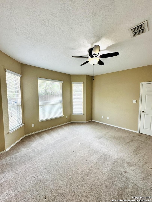 4602 Todds Farm, San Antonio, TX 78244 - carpeted empty room featuring a ceiling fan, baseboards, plenty of natural light, and a textured ceiling