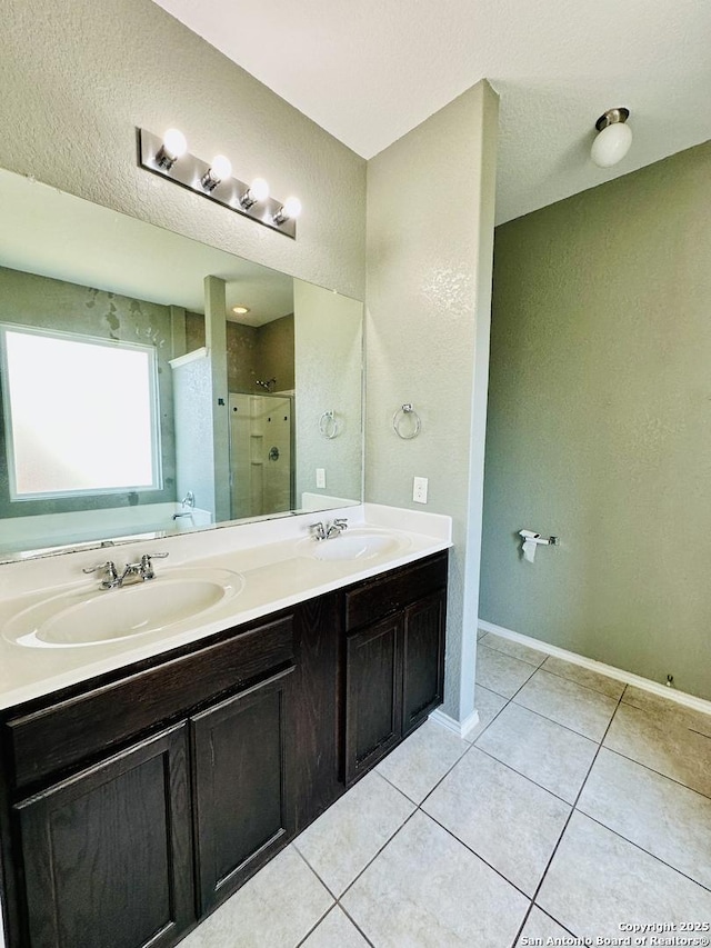 4602 Todds Farm, San Antonio, TX 78244 - full bathroom featuring double vanity, a shower stall, tile patterned flooring, baseboards, and a textured wall