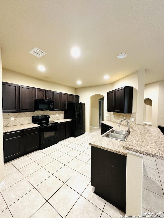 4602 Todds Farm, San Antonio, TX 78244 - kitchen with black appliances, a sink, arched walkways, a peninsula, and decorative backsplash