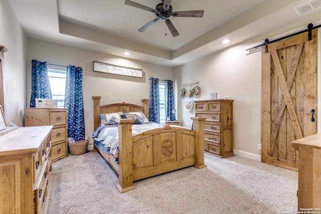 688 Double Gate Rd, Castroville, TX 78009 - bedroom featuring a barn door, light colored carpet, recessed lighting, a raised ceiling, and ceiling fan