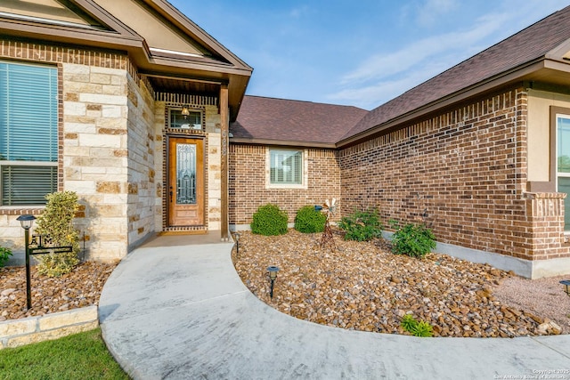 688 Double Gate Rd, Castroville, TX 78009 - doorway to property with brick siding, roof with shingles, and stone siding