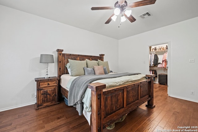 788 San Luis, New Braunfels, TX 78132 - bedroom featuring dark wood-style flooring, a spacious closet, baseboards, and ceiling fan