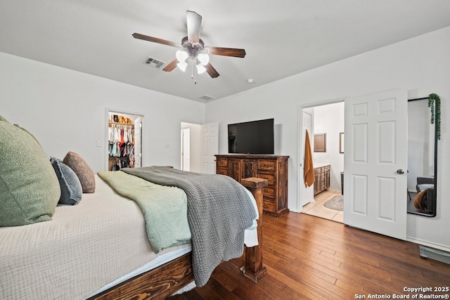 788 San Luis, New Braunfels, TX 78132 - bedroom featuring a walk in closet, hardwood / wood-style flooring, a closet, ensuite bathroom, and ceiling fan