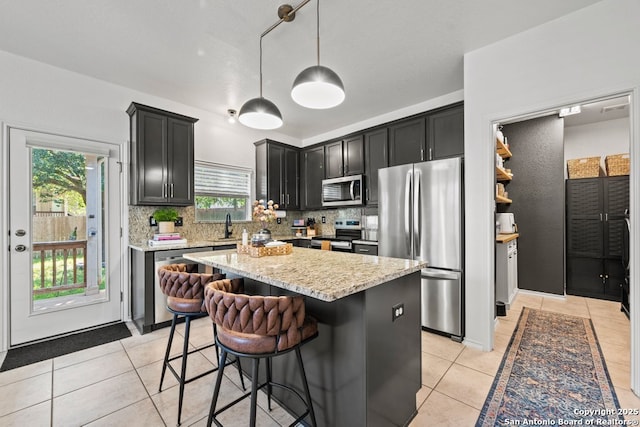 788 San Luis, New Braunfels, TX 78132 - kitchen featuring stainless steel appliances, light tile patterned floors, light stone counters, and a sink