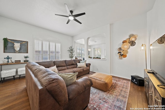 788 San Luis, New Braunfels, TX 78132 - living area featuring a ceiling fan, dark wood-style floors, arched walkways, and baseboards