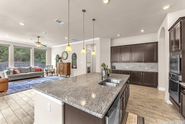 11926 Tower Crk, San Antonio, TX 78253 - kitchen with a sink, appliances with stainless steel finishes, ceiling fan, dark brown cabinets, and crown molding