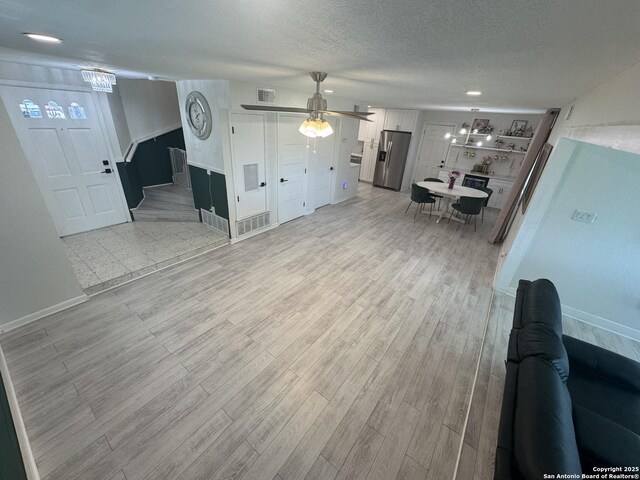 430 Indigo, San Antonio, TX 78216 - living area with baseboards, light wood-type flooring, a textured ceiling, and ceiling fan