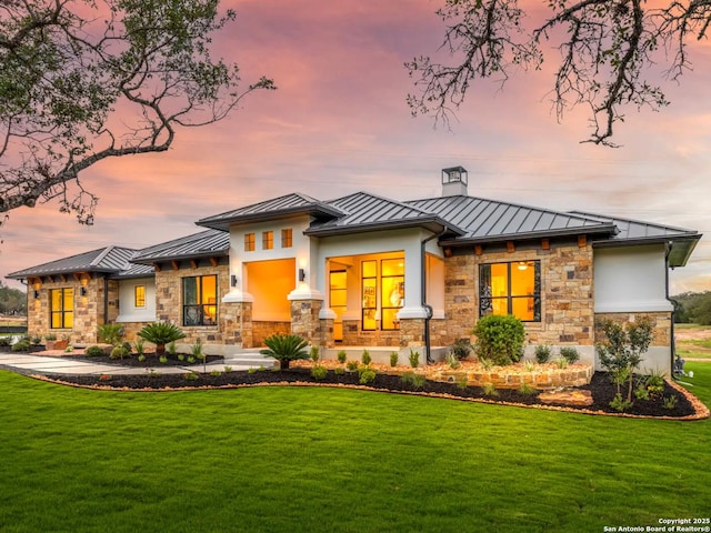 1217 Rio Central, Spring Branch, TX 78070 - back of property at dusk featuring a standing seam roof, metal roof, and a lawn