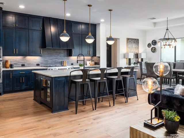 1217 Rio Central, Spring Branch, TX 78070 - kitchen with a breakfast bar area, backsplash, light countertops, light wood-style floors, and recessed lighting