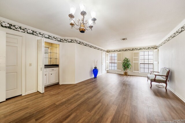 5359 Fredericksburg Unit 513, San Antonio, TX 78229 - unfurnished room featuring wood finished floors, a chandelier, ornamental molding, and baseboards