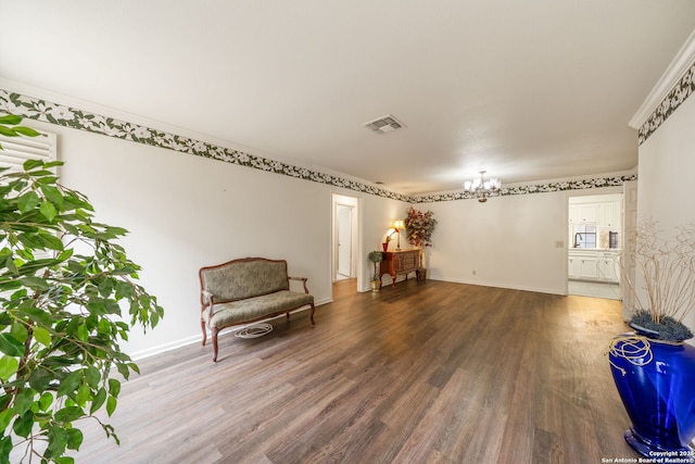 5359 Fredericksburg Unit 513, San Antonio, TX 78229 - living area with a chandelier, wood finished floors, crown molding, and baseboards
