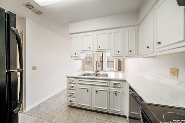 5359 Fredericksburg Unit 513, San Antonio, TX 78229 - kitchen with freestanding refrigerator, a sink, white cabinets, and light tile patterned floors