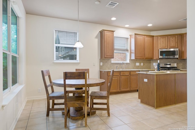 1711 Mountain, San Antonio, TX 78258 - kitchen with appliances with stainless steel finishes, tasteful backsplash, light countertops, decorative light fixtures, and recessed lighting