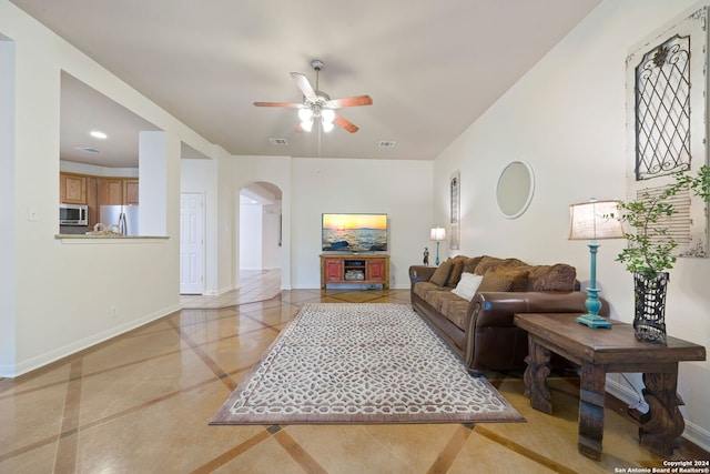 1711 Mountain, San Antonio, TX 78258 - living area featuring arched walkways, ceiling fan, baseboards, and light tile patterned floors