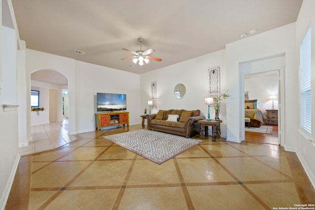 1711 Mountain, San Antonio, TX 78258 - living area with arched walkways, a ceiling fan, inlaid floor details, and plenty of natural light