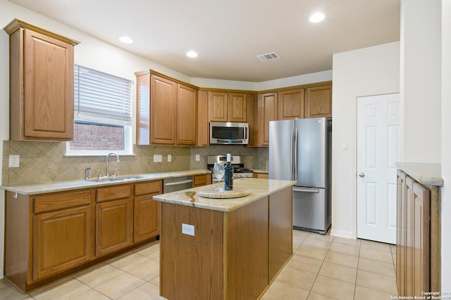1711 Mountain, San Antonio, TX 78258 - kitchen with appliances with stainless steel finishes, a sink, light tile patterned flooring, a center island, and recessed lighting