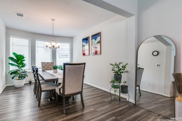 12918 Lilly Pass, San Antonio, TX 78254 - dining room with dark wood-style floors, a chandelier, baseboards, and arched walkways
