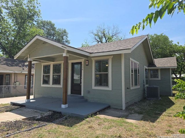 124 Baylor, San Antonio, TX 78204 - view of front of property with central air condition unit and roof with shingles