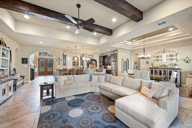 136 Eagle Crst, Spring Branch, TX 78070 - living area with a chandelier, arched walkways, beamed ceiling, a ceiling fan, and baseboards