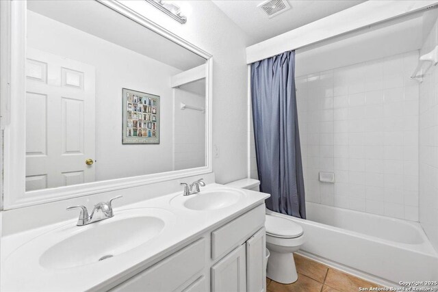 211 Rock Spgs, New Braunfels, TX 78130 - bathroom with toilet, double vanity, tile patterned flooring, and shower / tub combo