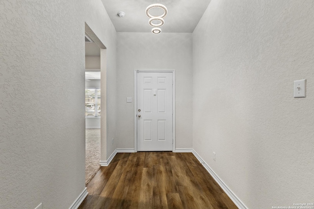 6910 Emerald Vly, San Antonio, TX 78242 - doorway featuring a textured wall, wood finished floors, and baseboards