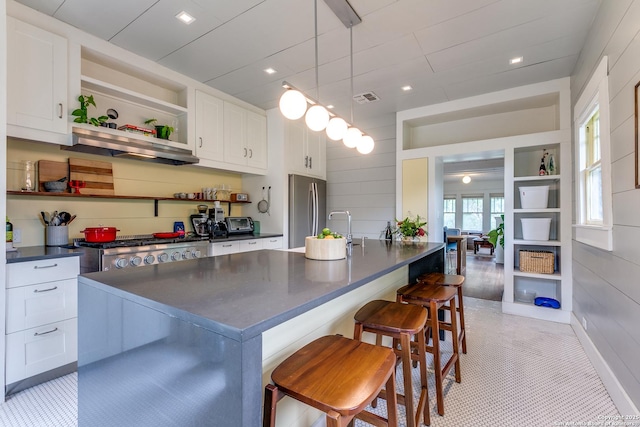 1007AND1013 Fulton, San Antonio, TX 78201 - kitchen with freestanding refrigerator, dark countertops, open shelves, and white cabinetry