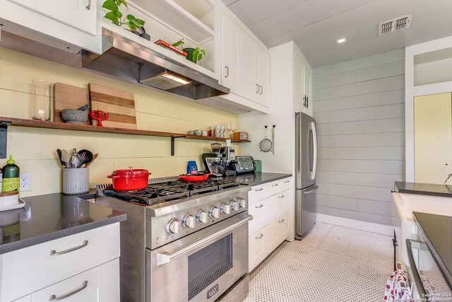 1007AND1013 Fulton, San Antonio, TX 78201 - kitchen featuring appliances with stainless steel finishes, open shelves, extractor fan, dark countertops, and white cabinets
