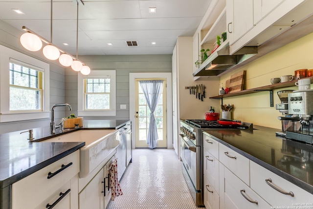1007AND1013 Fulton, San Antonio, TX 78201 - kitchen with high end stainless steel range oven, open shelves, a sink, and dark countertops
