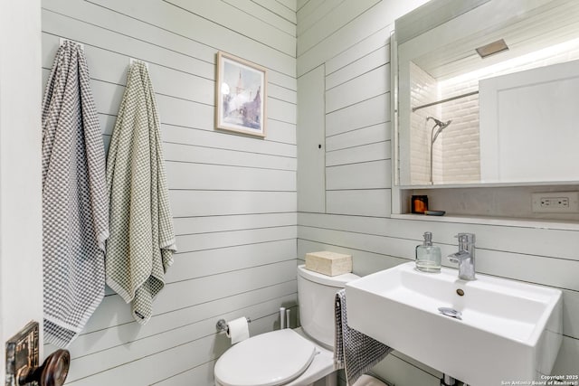 1007AND1013 Fulton, San Antonio, TX 78201 - bathroom featuring toilet, wood walls, a sink, and a shower