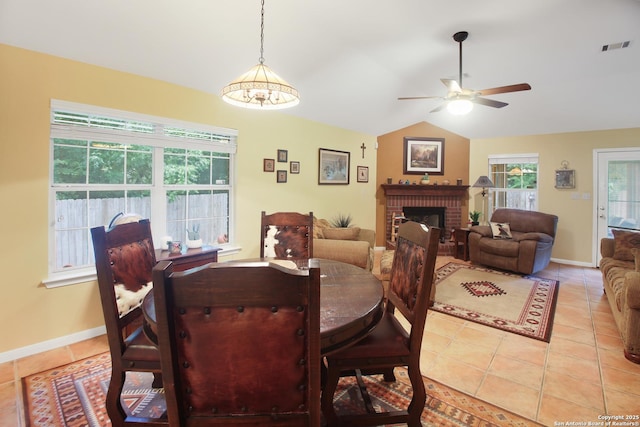 9519 Braun Shr, San Antonio, TX 78250 - dining area featuring a ceiling fan, light tile patterned floors, a fireplace, lofted ceiling, and baseboards