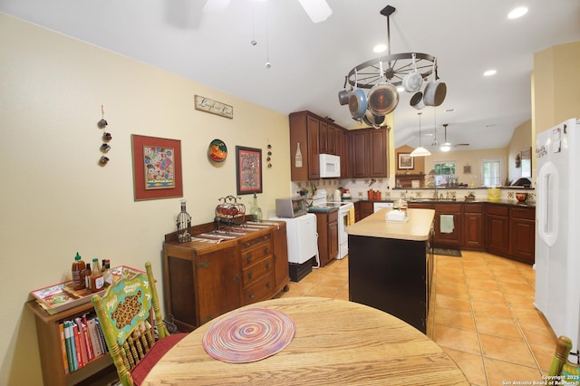 9519 Braun Shr, San Antonio, TX 78250 - kitchen featuring white appliances, ceiling fan, a sink, a center island, and light tile patterned floors